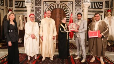 أشرفت رئيسة الحكومة السيدة نجلاء بودن رمضان اليوم الاربعاء 16 مارس 2022 بقصر الحكومة بالقصبة، على موكب لتكريم عدد من الحرفيين بمناسبة الاحتفال باليوم الوطني للباس التقليدي، وذلك بحضور وزير السياحة السيد محمد المعز بلحسين، ورئيس الاتحاد التونسي للصناعة والتجارة والصناعات التقليدية السيد سمير ماجول.